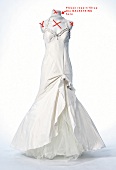 Close-up of white wedding dress on white background