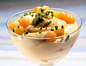 Cream of melon with wine and pistachios in glass bowl
