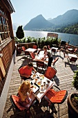 People sitting at restaurant on wooden deck