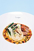 Grilled tuna served with fennel compote and harissa sauce on plate