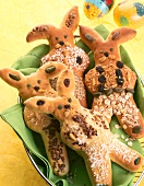 Close-up of bunny shaped buns with shredded coconut, raisins, almonds and nuts