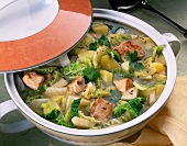 Savoy cabbage stew with turkey cutlets in pan