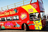 View of red sightseeing bus on street, South Africa