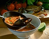 Blue crab soup with shell in bowl with spoon, Mexico