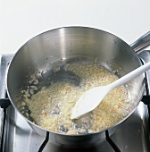 Shallot cubes being cooked in pot, step 1