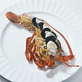 Lobster with truffles and vegetables on plate for preparation of languste gratin, step 2