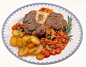 Braised shin of beef with roast potatoes and vegetables on plate