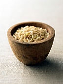 Brown rice in wooden bowl