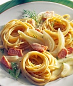 Spaghetti with smoked salmon, fennel and sauce on plate