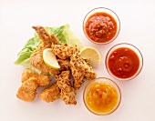 Fried chicken salad with breaded, lemon and dips sauce on white background