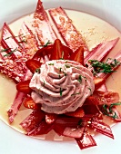 Close-up of rhubarb with strawberry cream, coconut and mint on plate