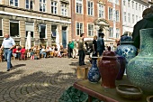 People at street cafe opposite to flea market in Nybrogade, Copenhagen, Denmark