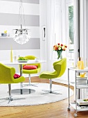Dining room with green chair on white fur carpet
