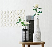 Chrysanthemums in gray and white vases with knitted covers