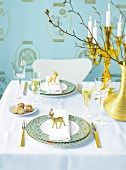 Golden vase with blue plates on table against blue background