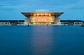 View of illuminated Royal Opera at night in Copenhagen, Denmark