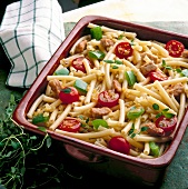 Macaroni with pork, tomatoes, peppers and thyme on serving dish