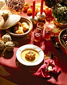 Close-up of table festively decorated in red with dishes and glasses