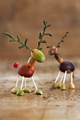 Tinkered little deers crafted from birch twigs, acorns and chestnuts