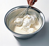 Whisking mixture of beer, flour and egg in bowl