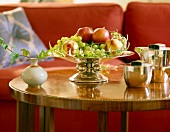 Bowl of grapes and apples on table