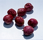 Red plum fruits on white background