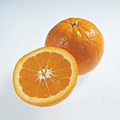Whole and halved salustiana oranges on white background