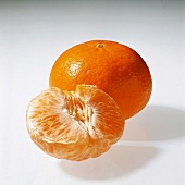 Whole and peeled tangerine orange on white background