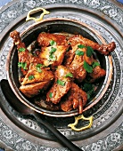 Spicy chicken with yogurt and parsley in antique bowl, India