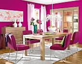 Dining room in pink with wooden furniture and green and white accessories