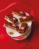 Almond-meringue slices dusted with cocoa powder and decorated with stars