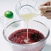 Lime juice being poured in tamarillo fruit puree