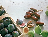 Fresh figs and dates in box and on floor