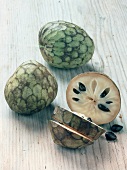 Whole and piece of cherimoya