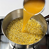 Clementine juice being poured in passion fruit pulp