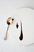Dark sauce on plate with spoon