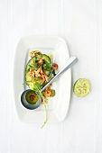 Avocado with prawns and vanilla oil on plate and spoon