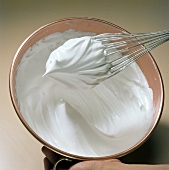 Cream being whisked for preparation of meringue, step 4