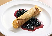 Wafer roll with blueberries on plate
