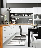 White kitchen-dining room with black accents