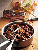 Wild sheep ragout with chanterelles in pan