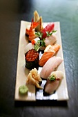 Various sushi on wooden board