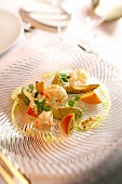 Norway lobster with marinated avocado and peach on plate