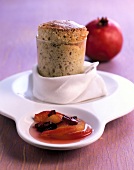 Close-up of hazelnut souffle with pomegranate compote on serving dish