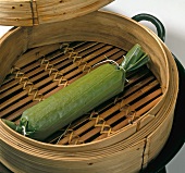 Steamed rice stuffed in banana leaf roll in bamboo basket, step 3