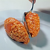 Close-up of tomato rice in round shape on plate