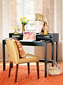 Black work desk with chair in orange and gold colour accents