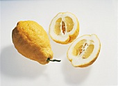 Whole and halved citron on white background