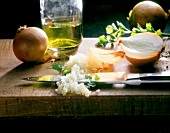 Rice, onions, oil, parsley, kitchen knives on wooden board, step 1