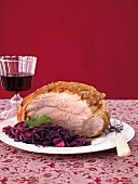 Shoulder of pork with red cabbage on plate